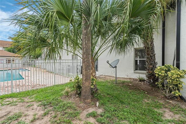 view of yard with a fenced in pool