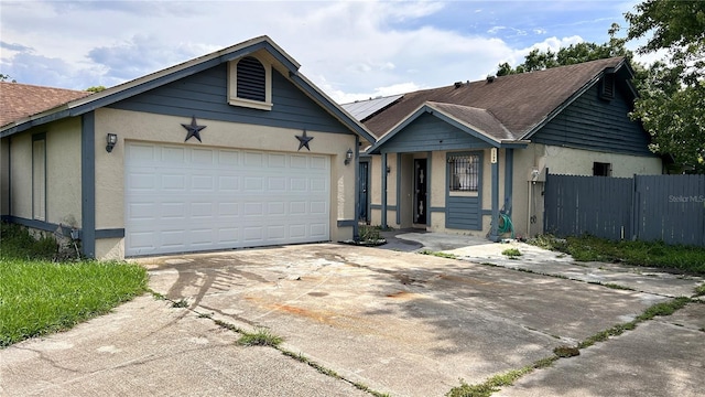 1204 Easton St, Orlando, FL 32825 - ranch-style house featuring stucco siding, concrete driveway, solar panels, and a garage