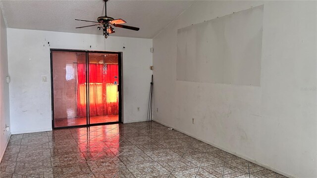 1204 Easton St, Orlando, FL 32825 - spare room with a ceiling fan, vaulted ceiling, a textured ceiling, and baseboards