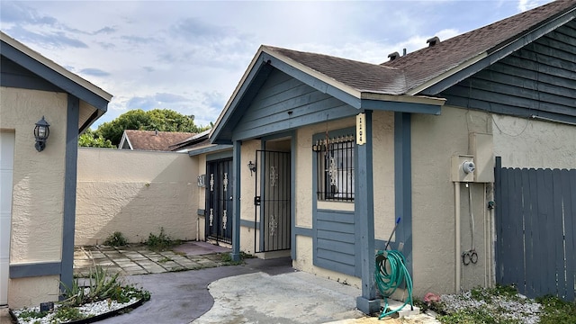 1204 Easton St, Orlando, FL 32825 - view of side of property with stucco siding and a shingled roof