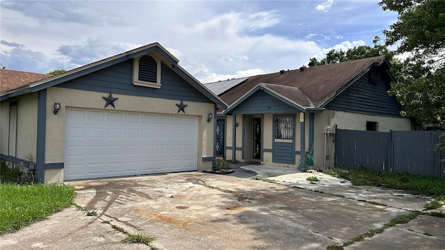 1204 Easton St, Orlando, FL 32825 - ranch-style house featuring stucco siding, driveway, a garage, and solar panels
