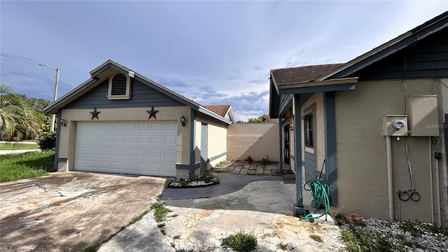 view of property exterior featuring a garage and an outdoor structure