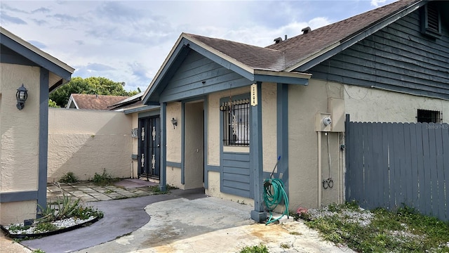 view of exterior entry with a patio area