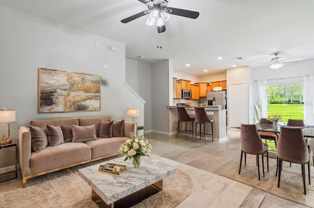 living room with light tile patterned flooring and ceiling fan