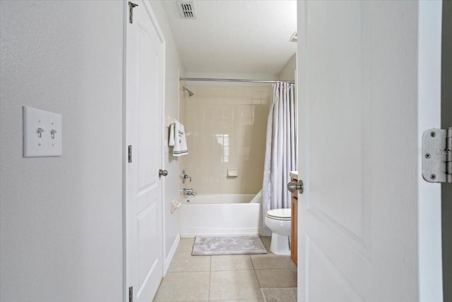 bathroom featuring tile patterned flooring, toilet, and shower / tub combo with curtain