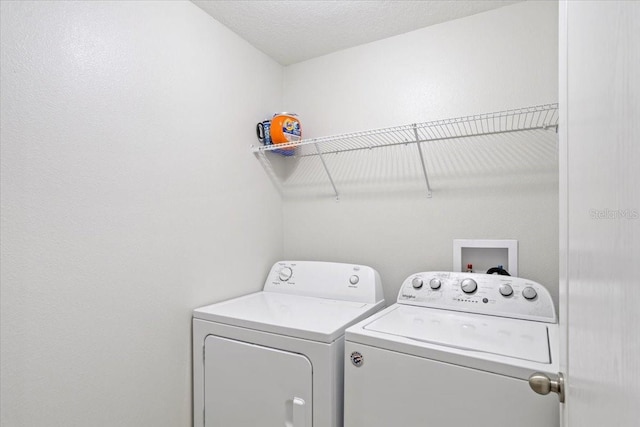 washroom featuring separate washer and dryer and a textured ceiling