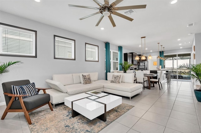 tiled living room with ceiling fan