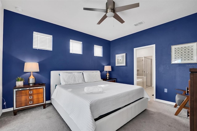 bedroom with carpet, ceiling fan, and connected bathroom