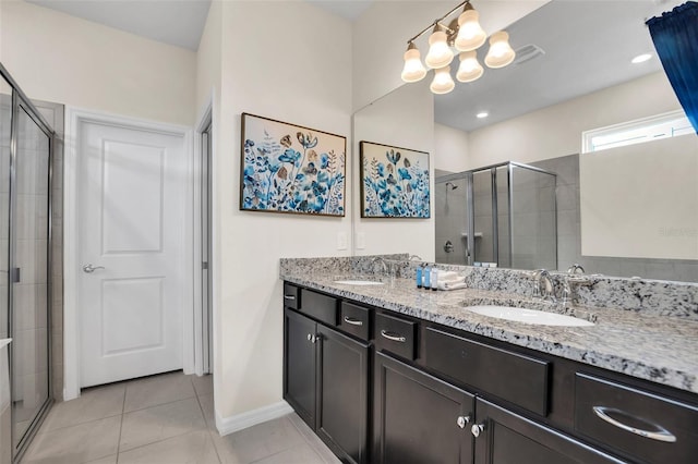 bathroom featuring tile flooring, walk in shower, double sink, and large vanity