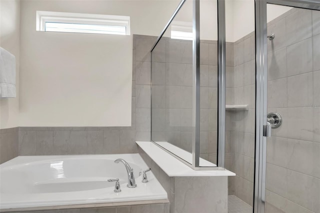 bathroom featuring shower with separate bathtub