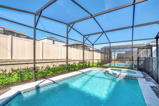 view of swimming pool featuring an in ground hot tub and a lanai