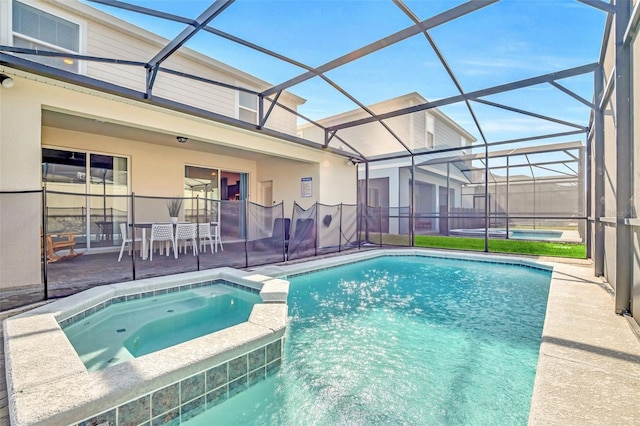 view of pool with an in ground hot tub, a lanai, and a patio area