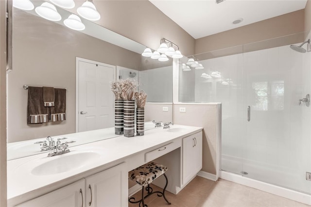 full bath featuring double vanity, tile patterned flooring, a shower stall, and a sink