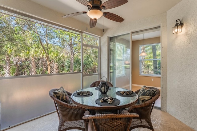 sunroom / solarium with a ceiling fan