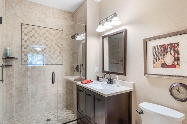 full bath with a shower stall, toilet, and vanity