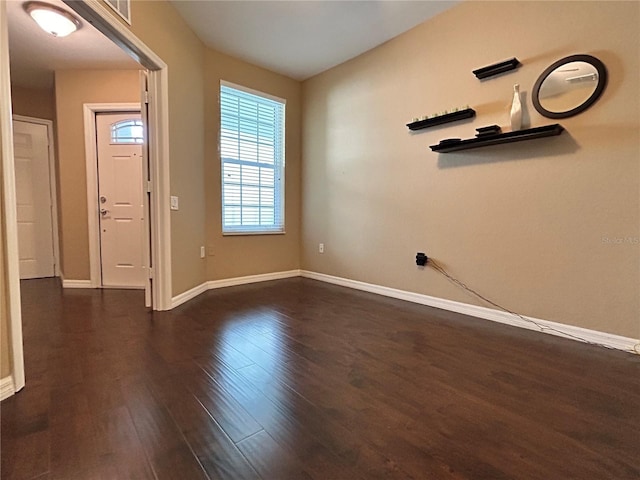 entrance foyer featuring dark wood-type flooring, visible vents, and baseboards