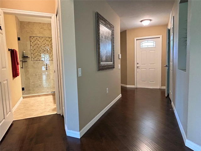 hallway with dark wood-style floors and baseboards