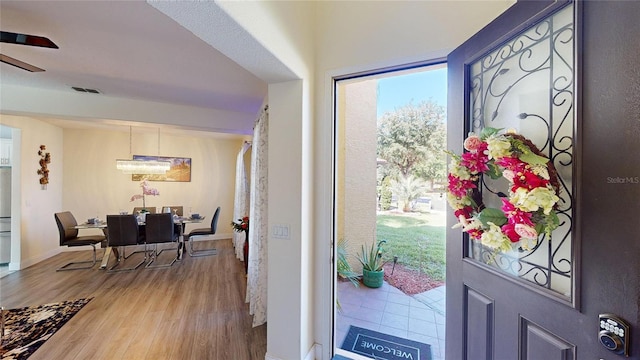 foyer featuring hardwood / wood-style flooring and ceiling fan