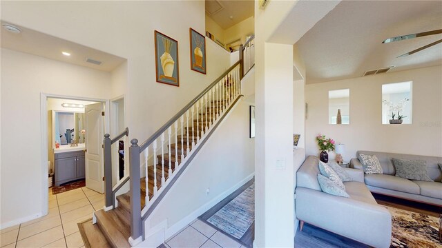 stairway with tile patterned flooring