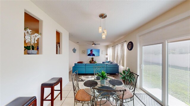 tiled dining area with plenty of natural light and ceiling fan