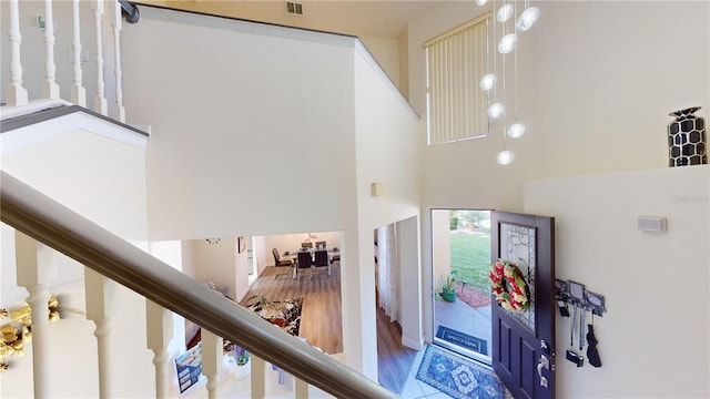 entrance foyer featuring hardwood / wood-style floors and a towering ceiling