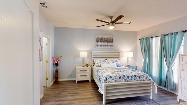 bedroom with ceiling fan and dark hardwood / wood-style floors