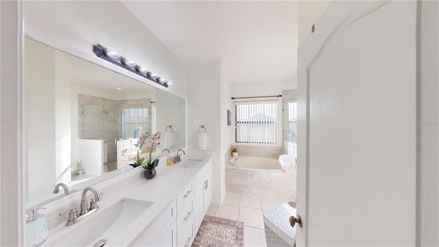 bathroom featuring tile patterned floors, vanity, and shower with separate bathtub