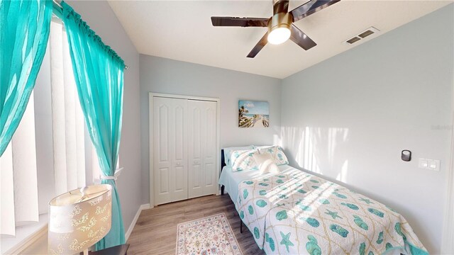 bedroom featuring light hardwood / wood-style flooring, a closet, and ceiling fan