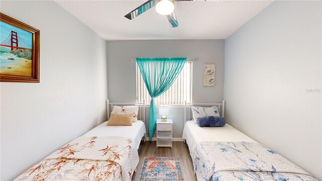 bedroom with hardwood / wood-style flooring and ceiling fan