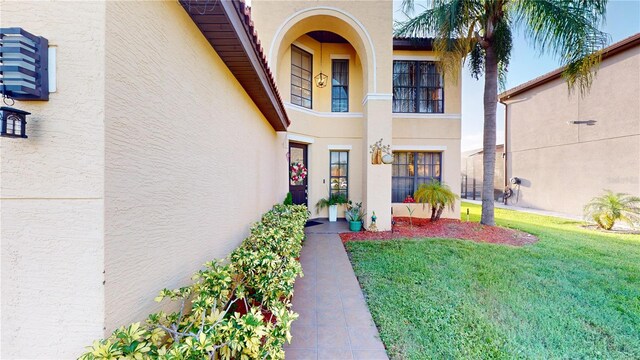 entrance to property with a lawn