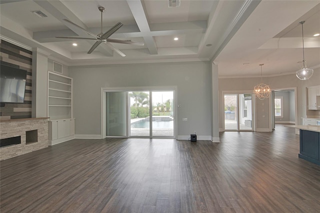 unfurnished living room featuring plenty of natural light, beam ceiling, built in shelves, and coffered ceiling