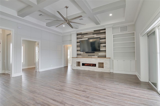 unfurnished living room with beam ceiling, built in shelves, coffered ceiling, hardwood / wood-style floors, and ornamental molding