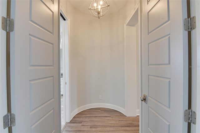 foyer featuring light hardwood / wood-style flooring and an inviting chandelier