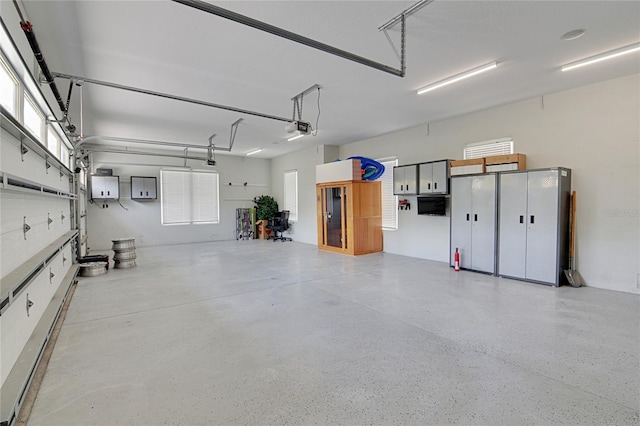 garage featuring electric panel and a garage door opener