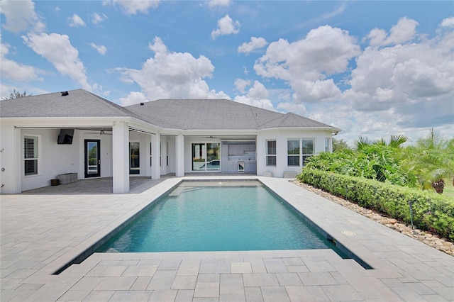 view of swimming pool with ceiling fan and a patio