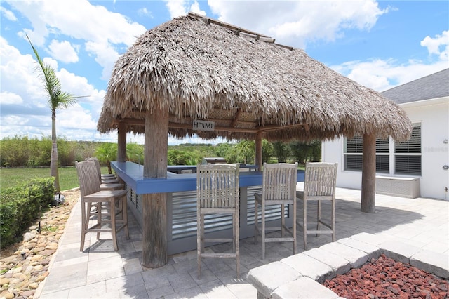 view of patio / terrace with a gazebo and a bar