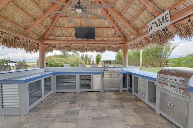 view of patio / terrace with a gazebo, area for grilling, ceiling fan, and an outdoor kitchen