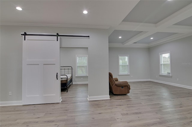 sitting room with a barn door, light hardwood / wood-style floors, and ornamental molding