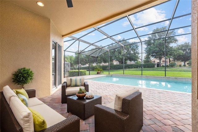 view of pool featuring a patio, an outdoor hangout area, and glass enclosure