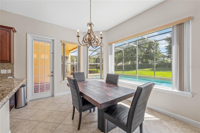 dining space featuring an inviting chandelier and light tile patterned flooring