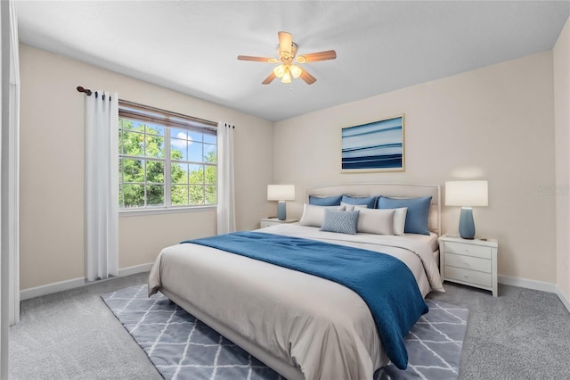 bedroom with dark carpet, baseboards, and ceiling fan