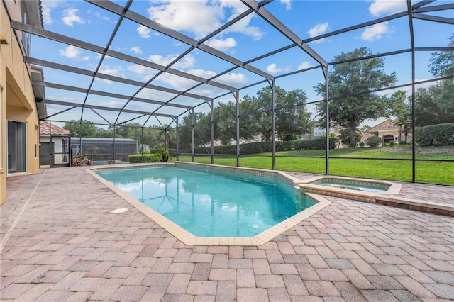 view of swimming pool with glass enclosure, a yard, a patio area, and a pool with connected hot tub