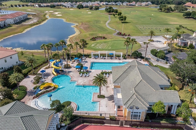 drone / aerial view with a water view and golf course view