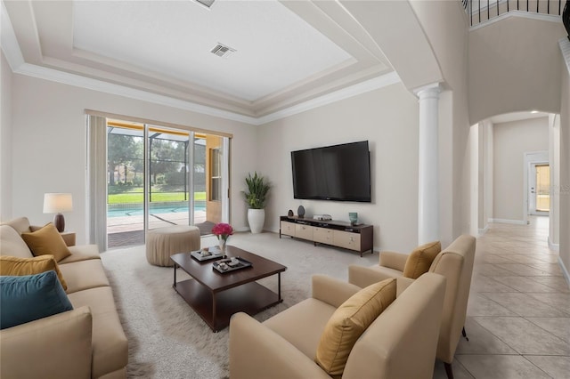 tiled living room featuring a tray ceiling, ornate columns, and crown molding