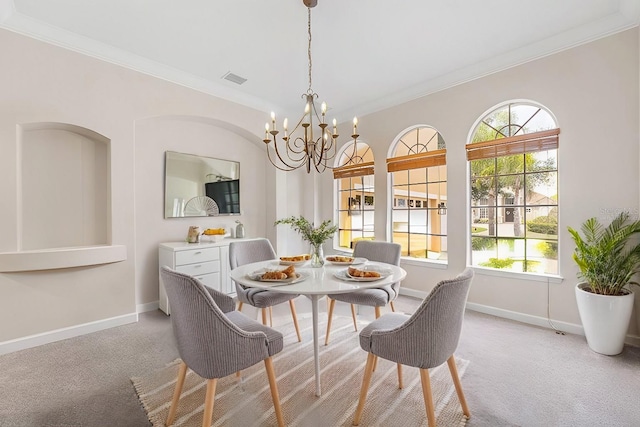 dining area with light colored carpet, crown molding, and baseboards