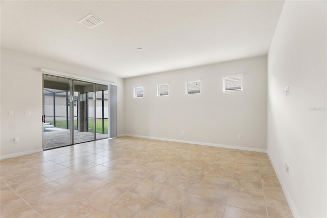 empty room with light tile patterned floors