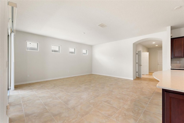 tiled spare room with a wealth of natural light