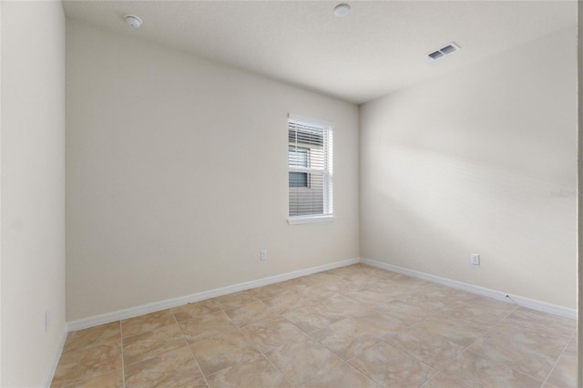 spare room with light tile patterned floors