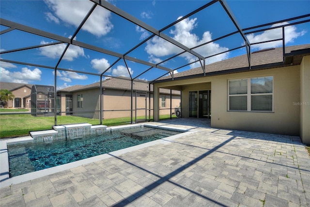 view of swimming pool with a lanai, a yard, and a patio