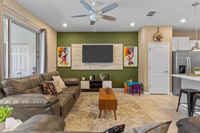 tiled living room featuring ceiling fan